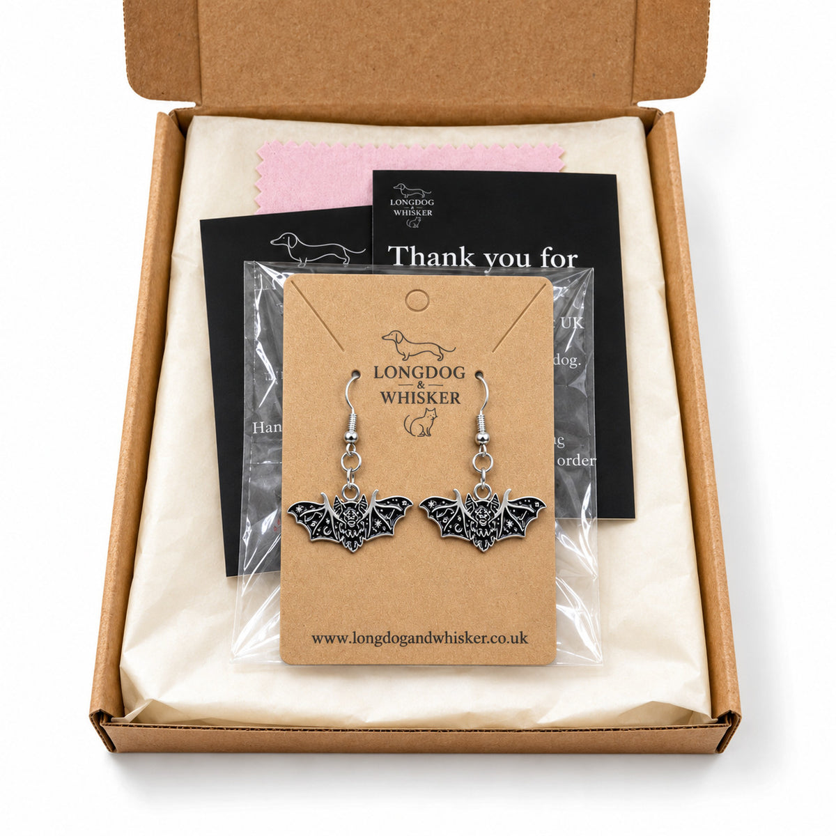 Fanged bat earrings presented in Longdog & Whisker packaging