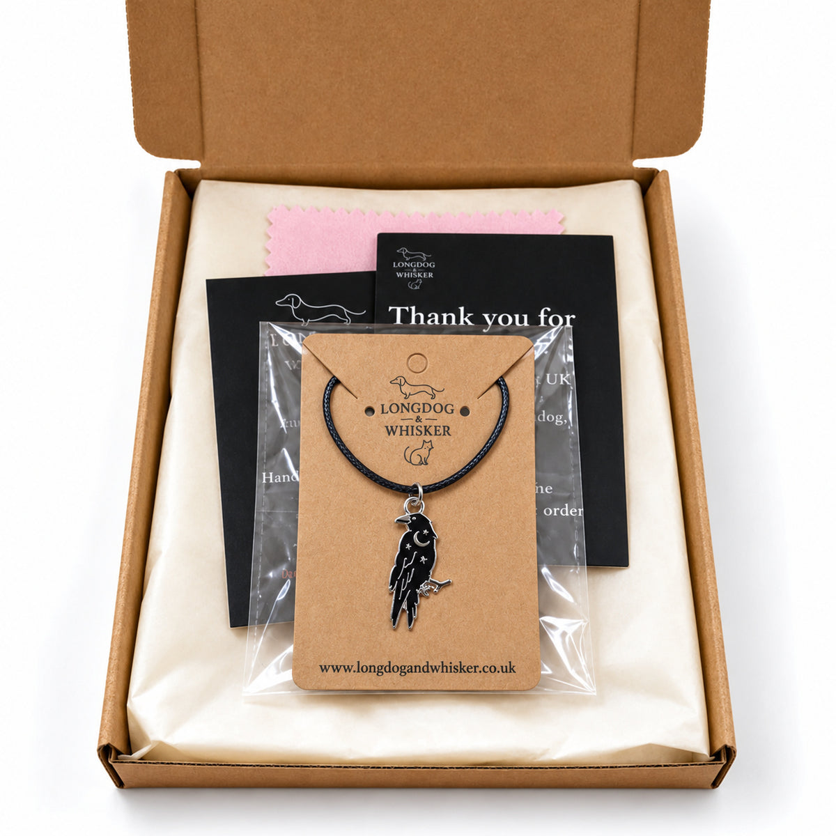 Black raven black-cord necklace in Longdog & Whisker postal packaging