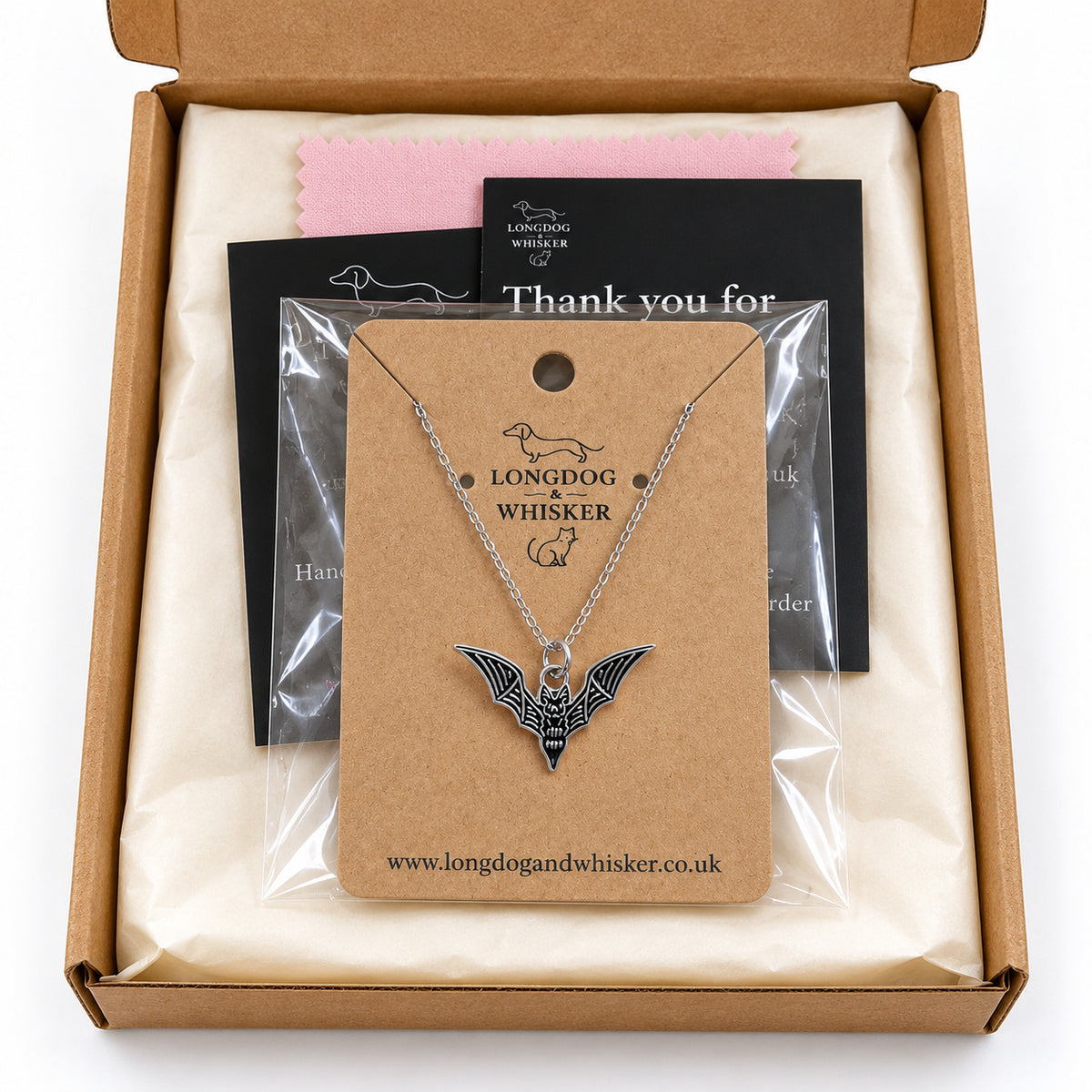 Black skeletal bat necklace on its card in Longdog & Whisker gift-ready packaging