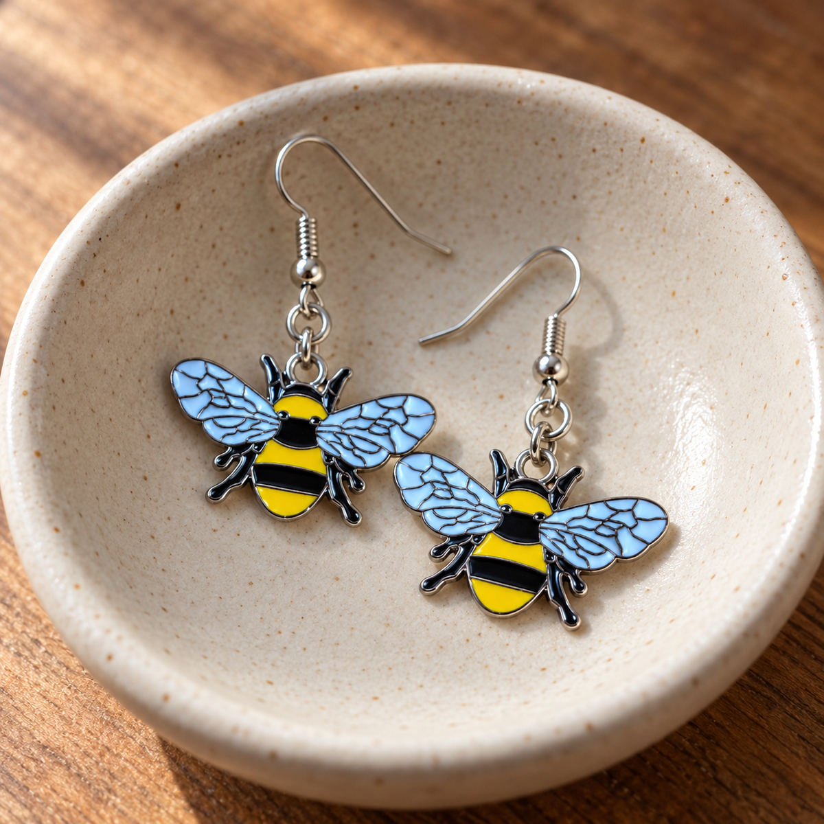Bumble Bee Earrings in a natural ceramic bowl lifestyle scene