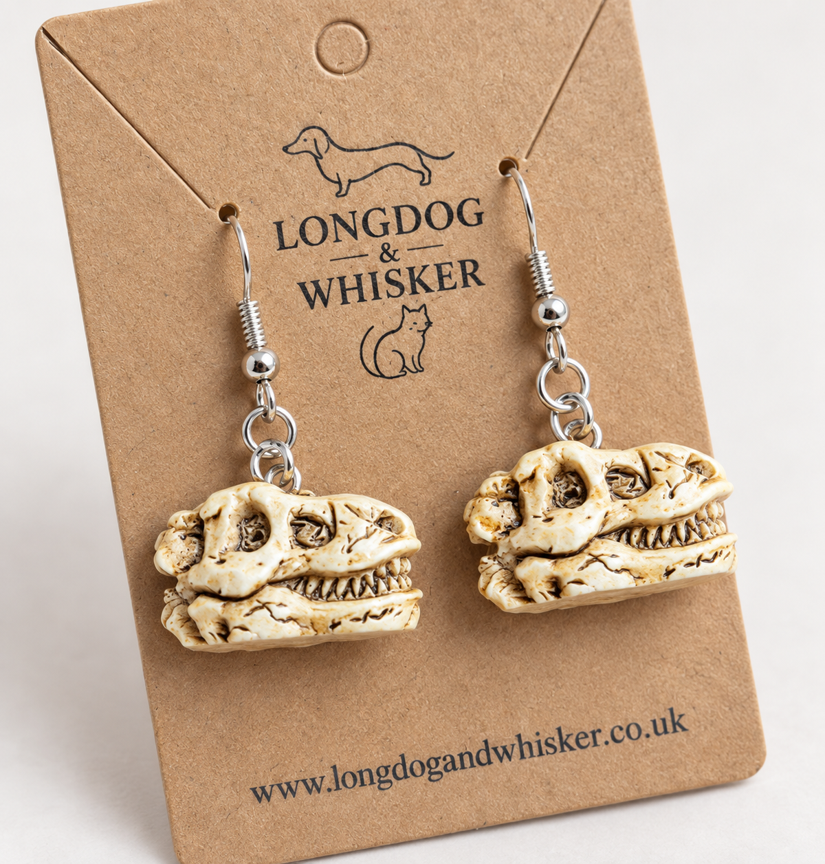 Close detail of fossil-style Dinosaur Skull Earrings