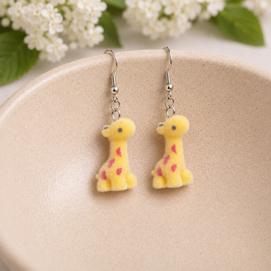 Fuzzy Giraffe Earrings displayed in a ceramic bowl