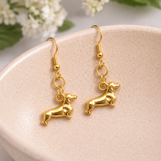 Sausage Dog Earrings - Gold displayed in a lifestyle product photo