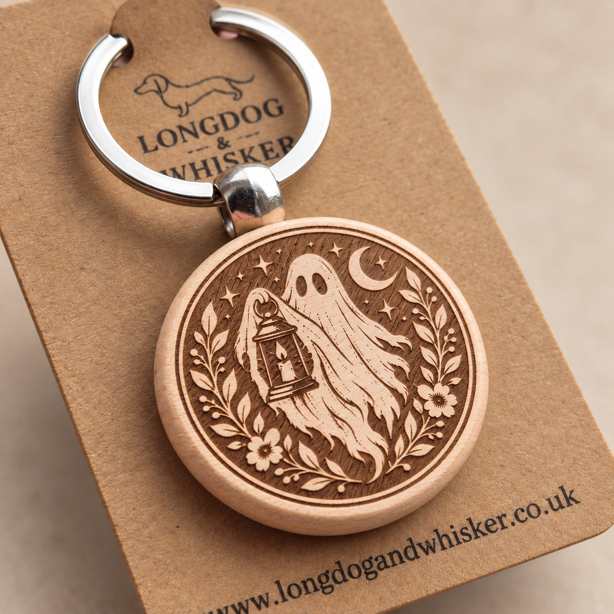Close-up of moonlit lantern ghost engraving on round wooden keyring