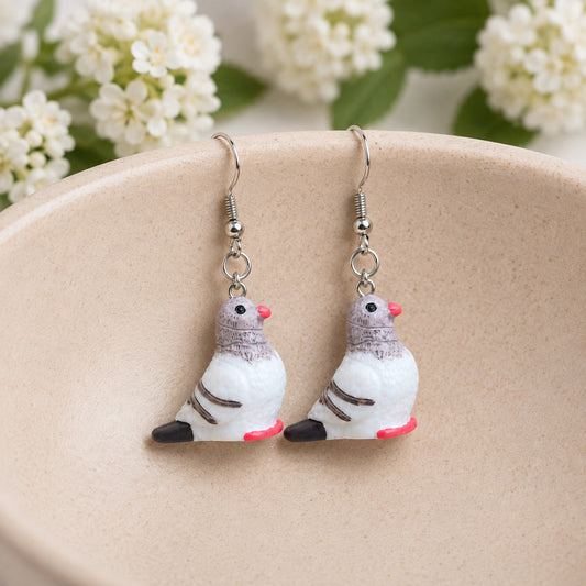 Pigeon Earrings displayed in a jewellery bowl lifestyle photo