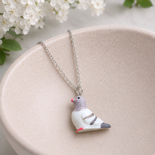 Pigeon Necklace displayed in a jewellery bowl lifestyle photo