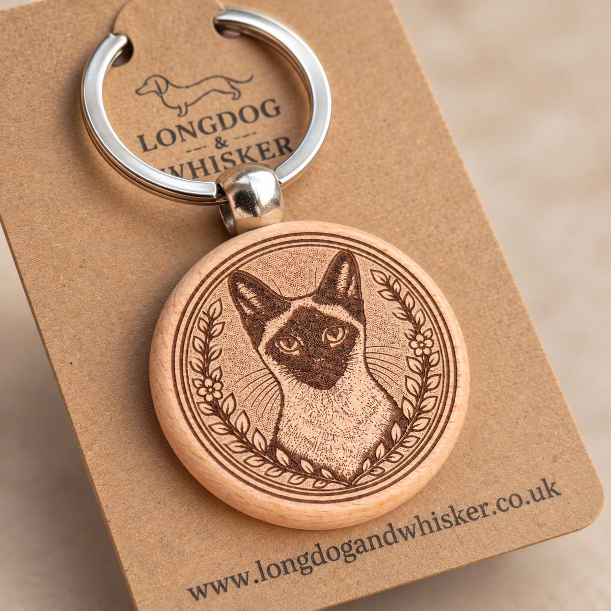 Close-up of the Siamese cat engraving, natural wooden edge and silver connector
