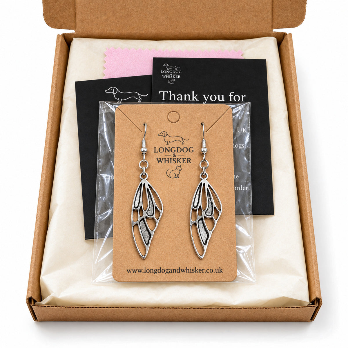 Silver-tone butterfly wing earrings in Longdog & Whisker kraft packaging