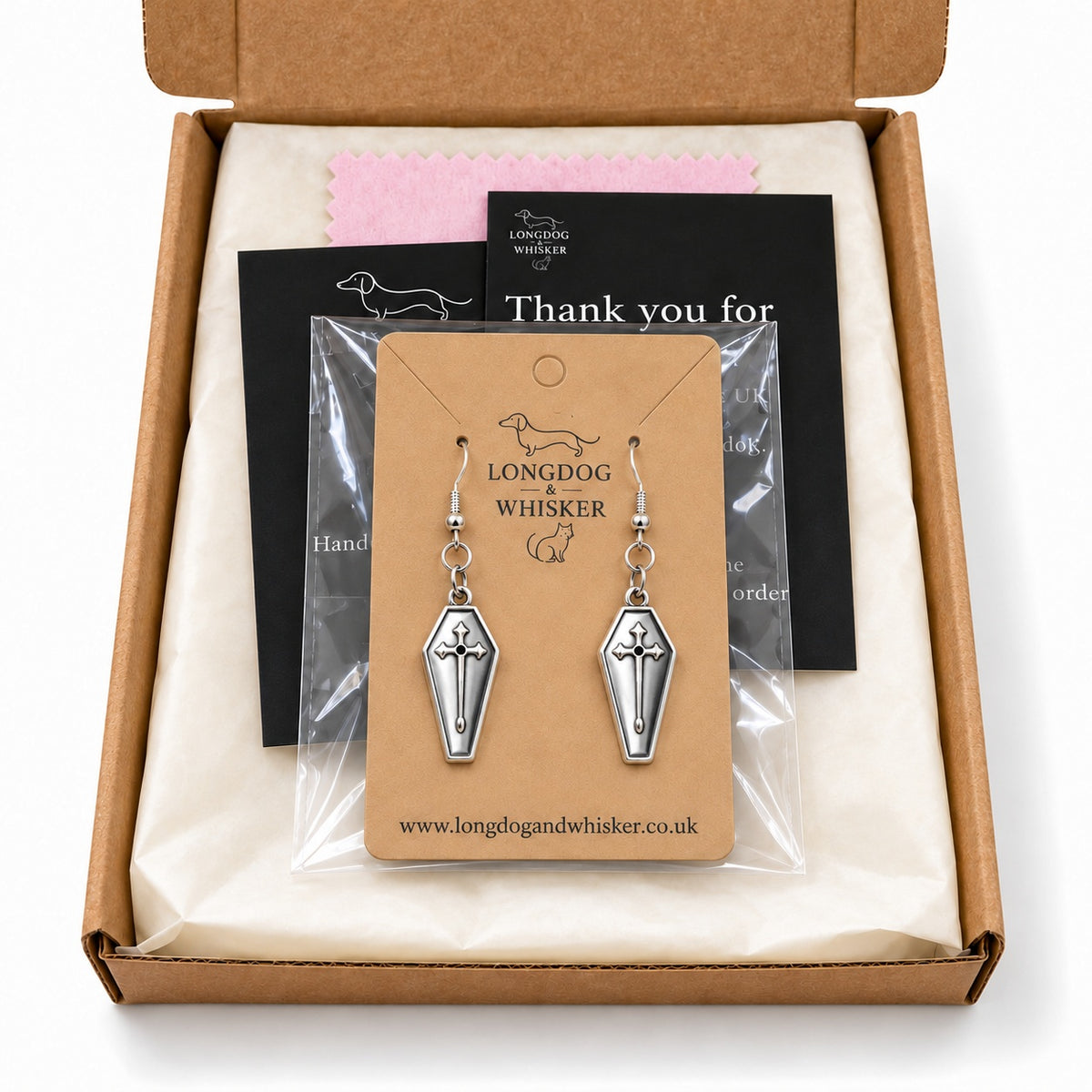 Silver coffin cross drop earrings in Longdog & Whisker postal packaging.