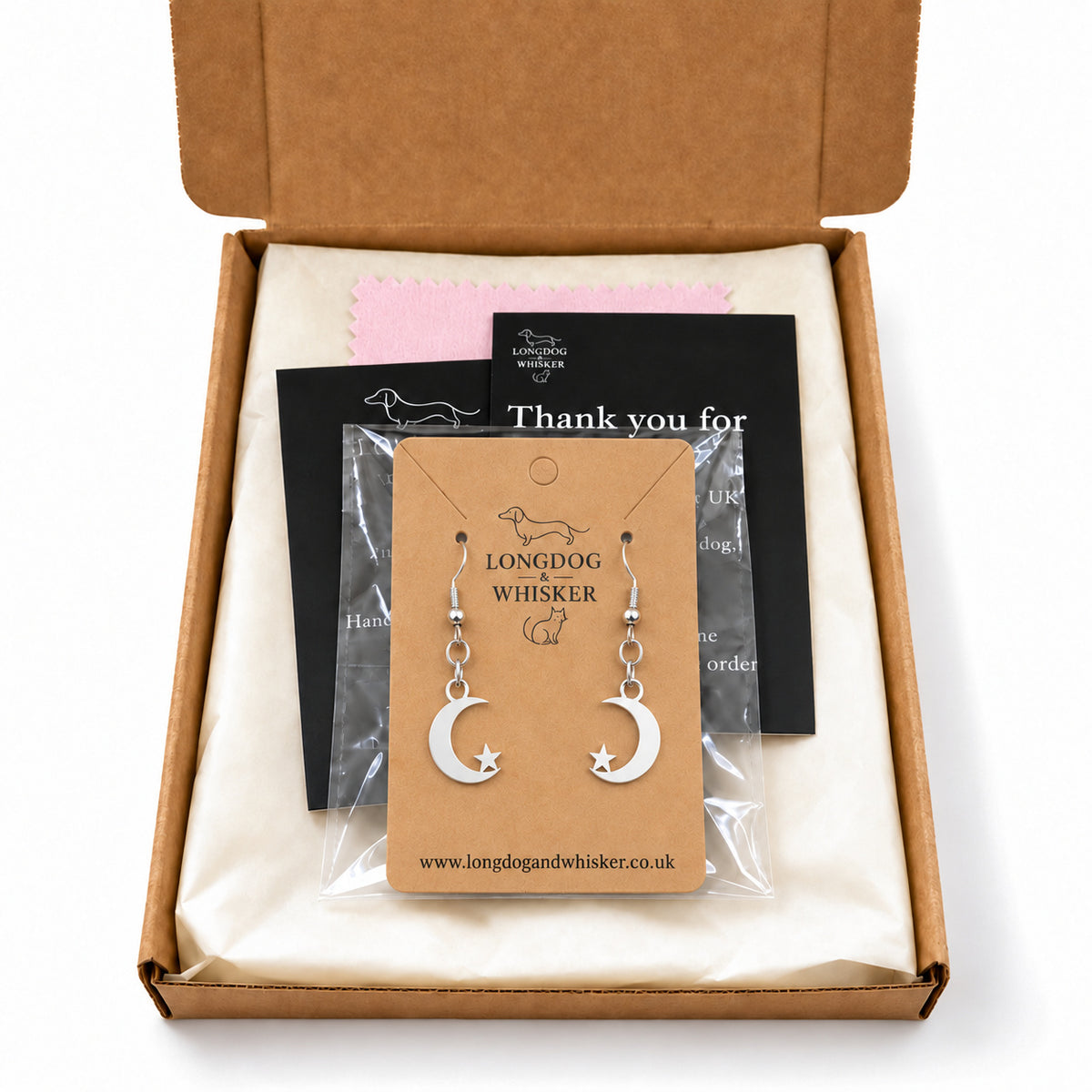 Silver moon and star earrings in Longdog & Whisker kraft packaging