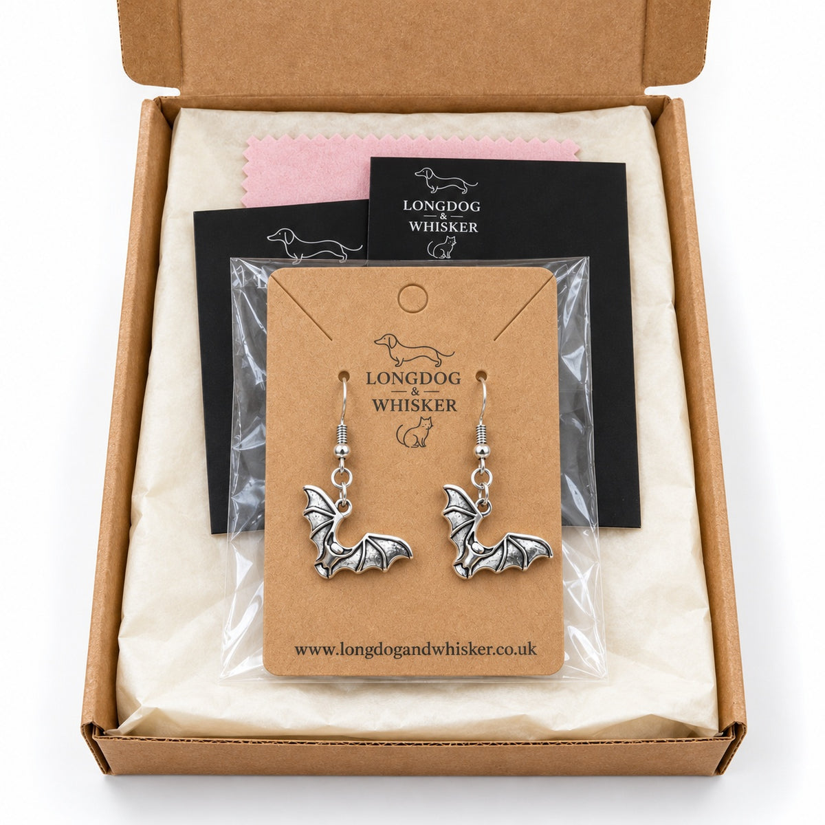 Silver-tone scalloped wing bat earrings on their kraft card in Longdog & Whisker packaging