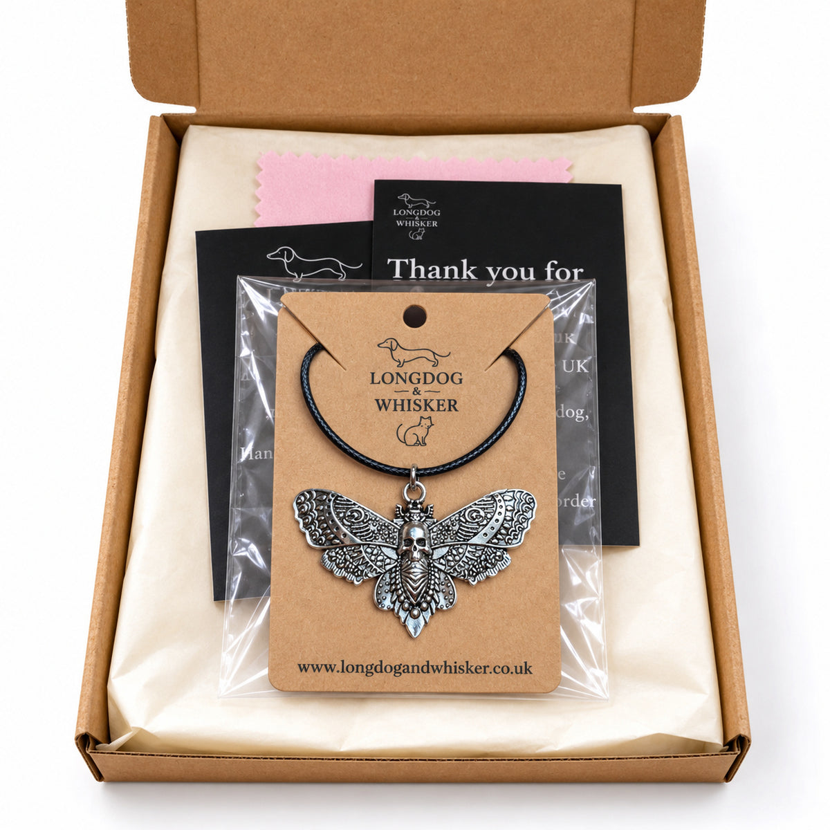 Silver skull moth black-cord necklace in Longdog & Whisker postal packaging