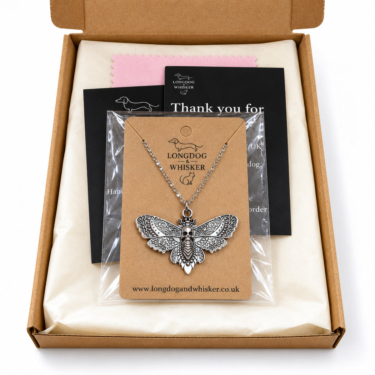 Silver skull moth silver-chain necklace in Longdog & Whisker postal packaging