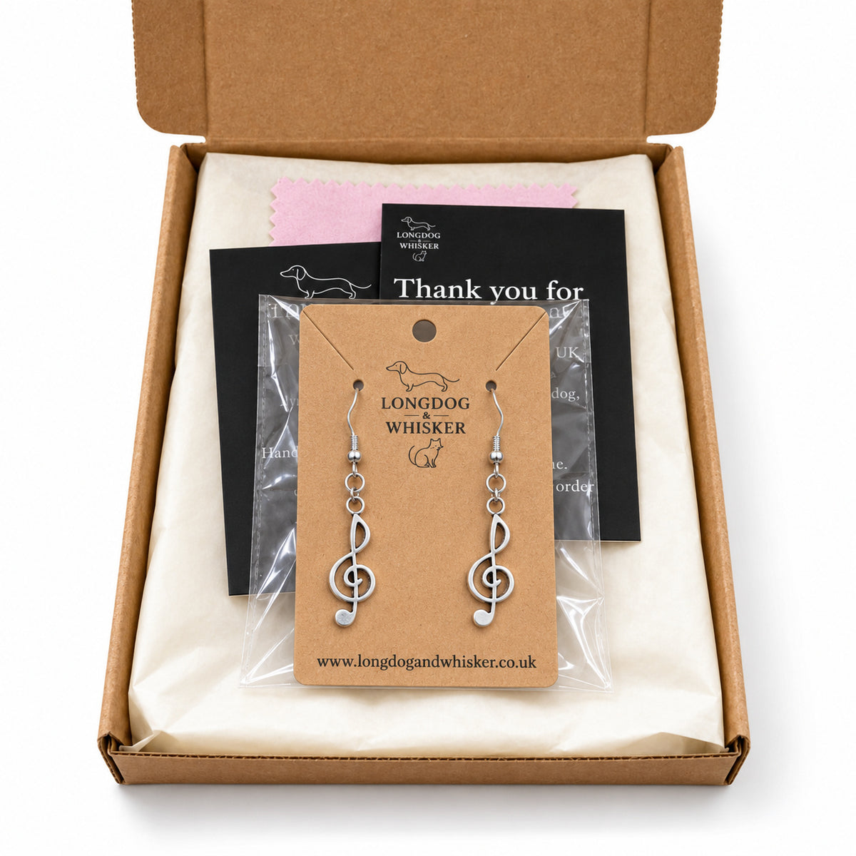 Silver-tone treble clef earrings in Longdog & Whisker kraft packaging