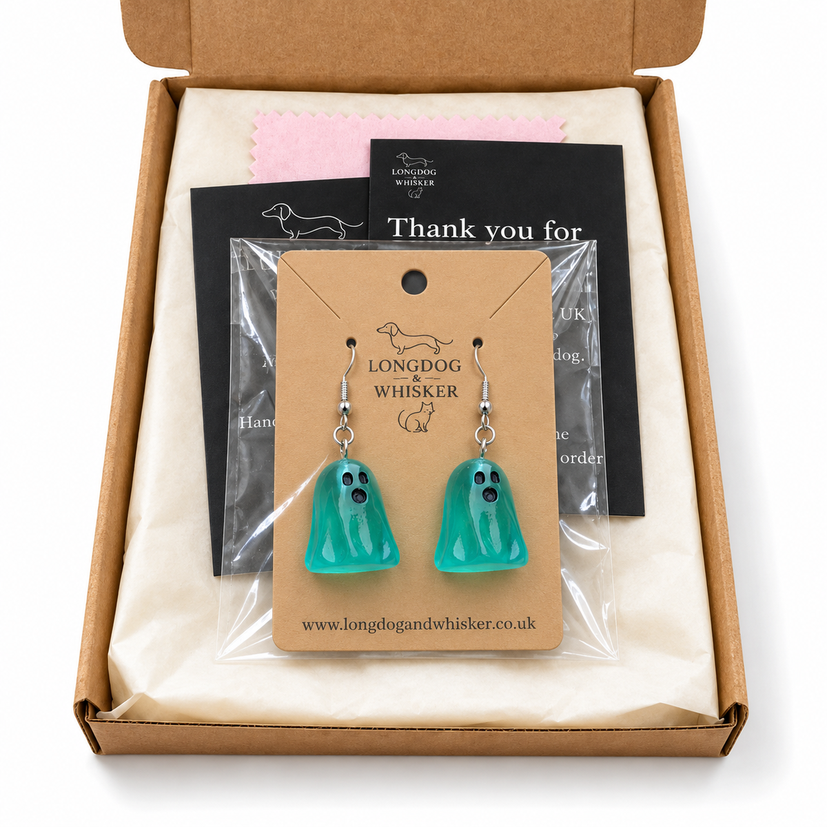 Aqua ghost earrings on their display card in Longdog & Whisker postal packaging.