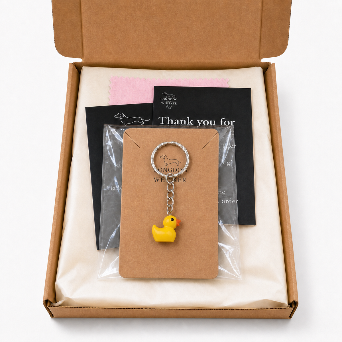 Yellow duck keyring on its Longdog & Whisker display card inside gift packaging