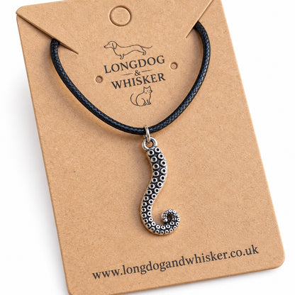 Close-up of curled tentacle pendant and suction cup detail