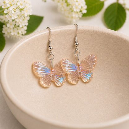 Aurora Butterfly Earrings - Apricot displayed in a bowl lifestyle photo