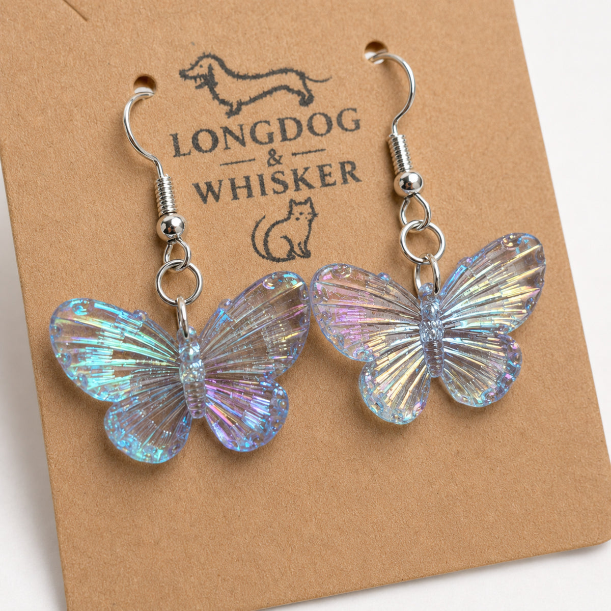 Close up of iridescent blue butterfly charm earrings