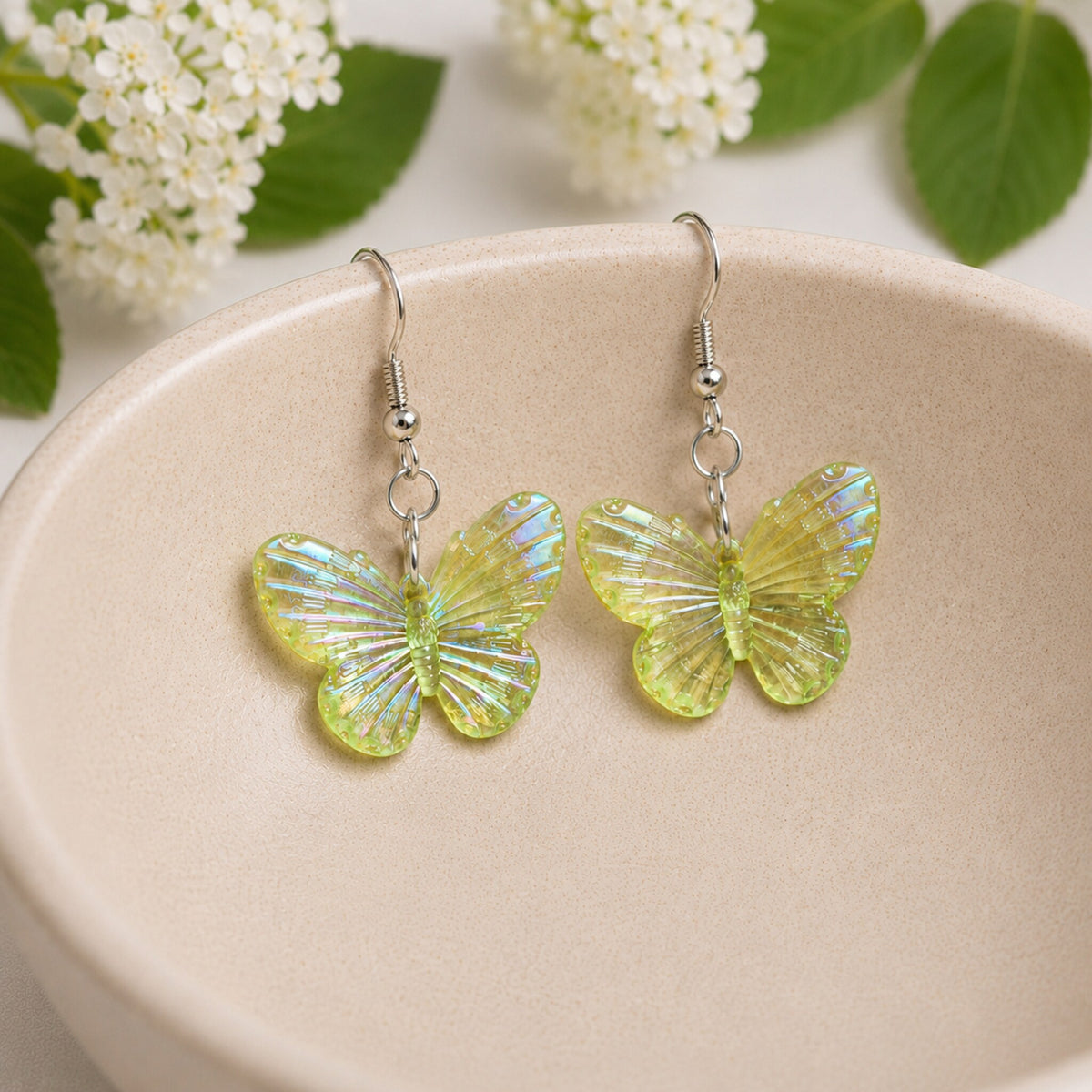 Aurora Butterfly Earrings - Lime Yellow displayed in a bowl lifestyle photo