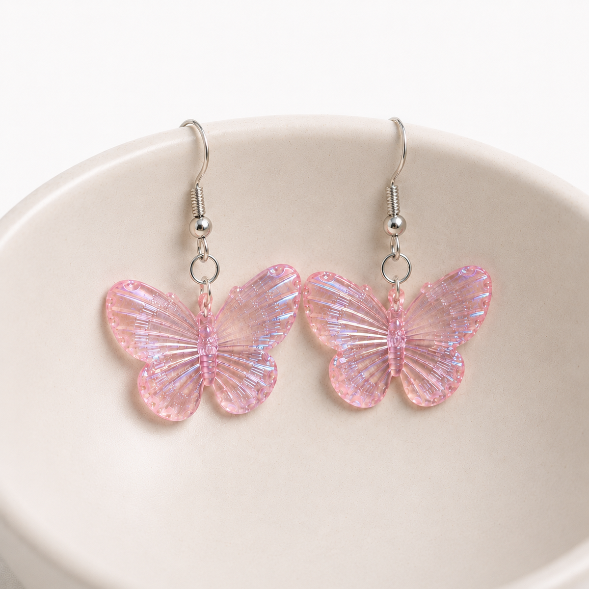 Aurora Butterfly Earrings - Pink displayed in a bowl lifestyle photo