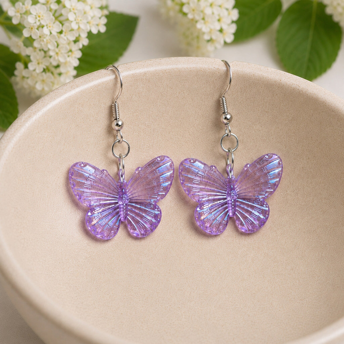 Aurora Butterfly Earrings - Purple displayed in a bowl lifestyle photo