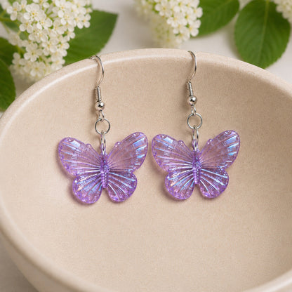 Aurora Butterfly Earrings - Purple displayed in a bowl lifestyle photo