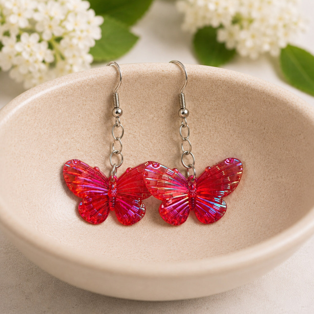 Aurora Butterfly Earrings - Red displayed in a bowl lifestyle photo