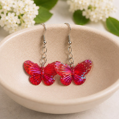 Aurora Butterfly Earrings - Red displayed in a bowl lifestyle photo
