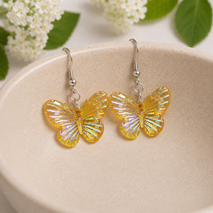 Aurora Butterfly Earrings - Yellow displayed in a bowl lifestyle photo