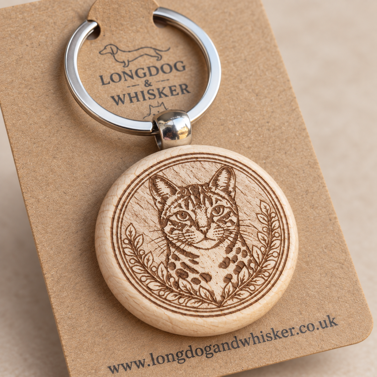 Close-up of the Bengal cat engraving and rounded wooden keyring edge