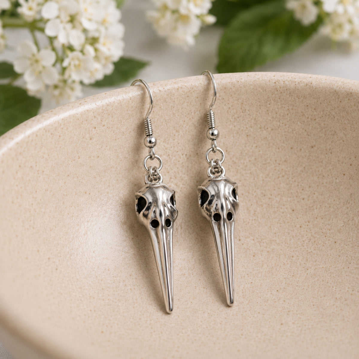 Classic Bird Skull Earrings displayed in a lifestyle product photo