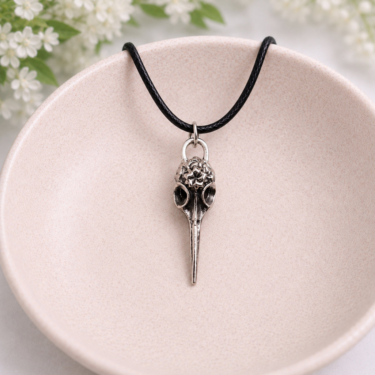 Floral Bird Skull Necklace displayed in a lifestyle product photo
