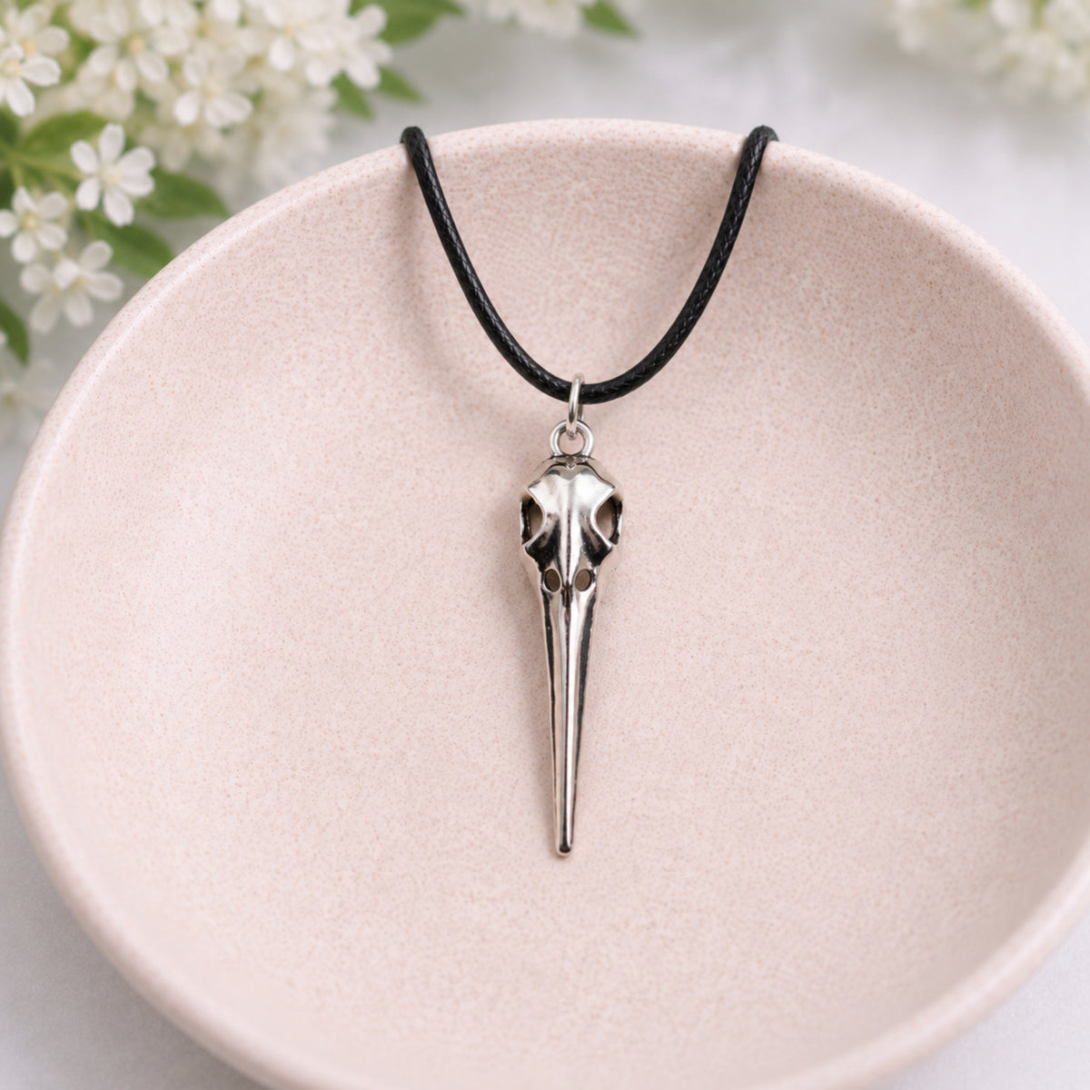 Classic Bird Skull Necklace displayed in a lifestyle product photo