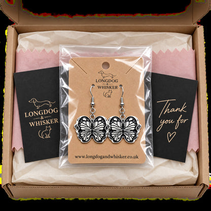 Black butterfly drop earrings in Longdog & Whisker packaging