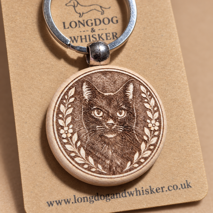 Close-up of the black cat engraving on a wooden keyring