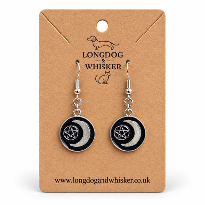 Black crescent moon and pentagram drop earrings on a Longdog & Whisker kraft product card