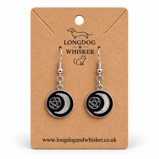 Black crescent moon and pentagram drop earrings on a Longdog & Whisker kraft product card
