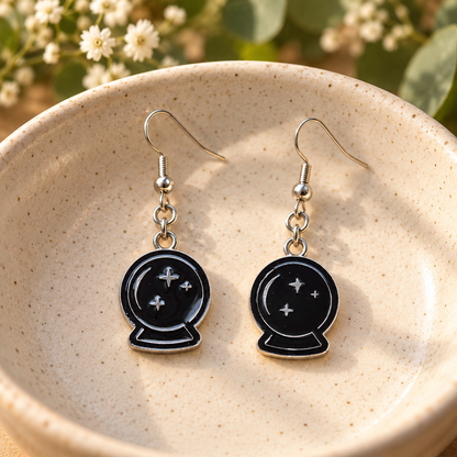 Black crystal ball drop earrings in a speckled ceramic bowl