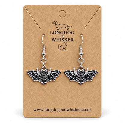Black and silver fanged bat drop earrings on Longdog & Whisker kraft card