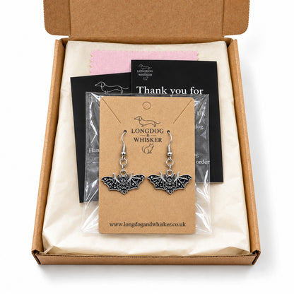 Fanged bat earrings presented in Longdog & Whisker packaging