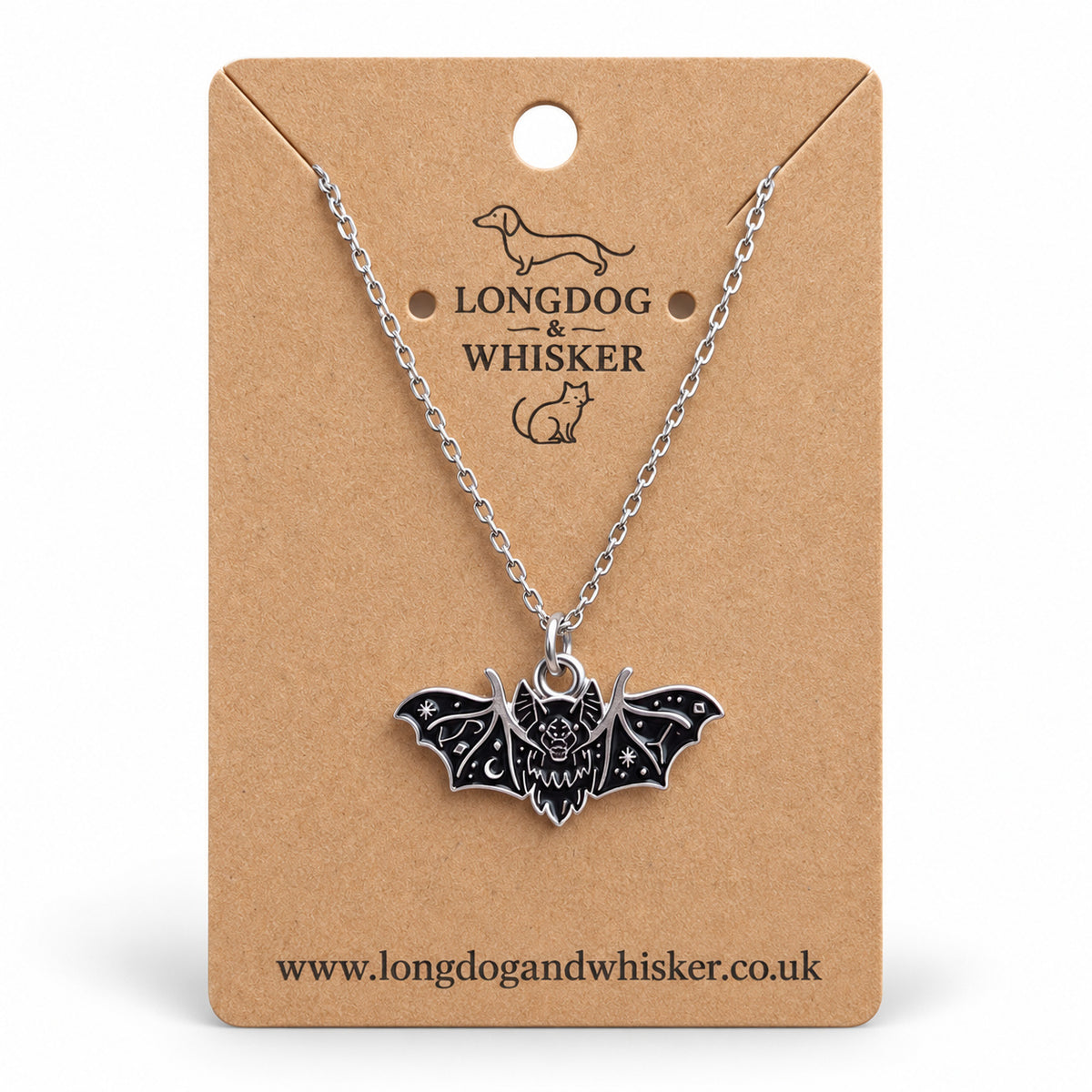 Black fanged bat necklace on a silver chain, displayed on a Longdog & Whisker kraft card