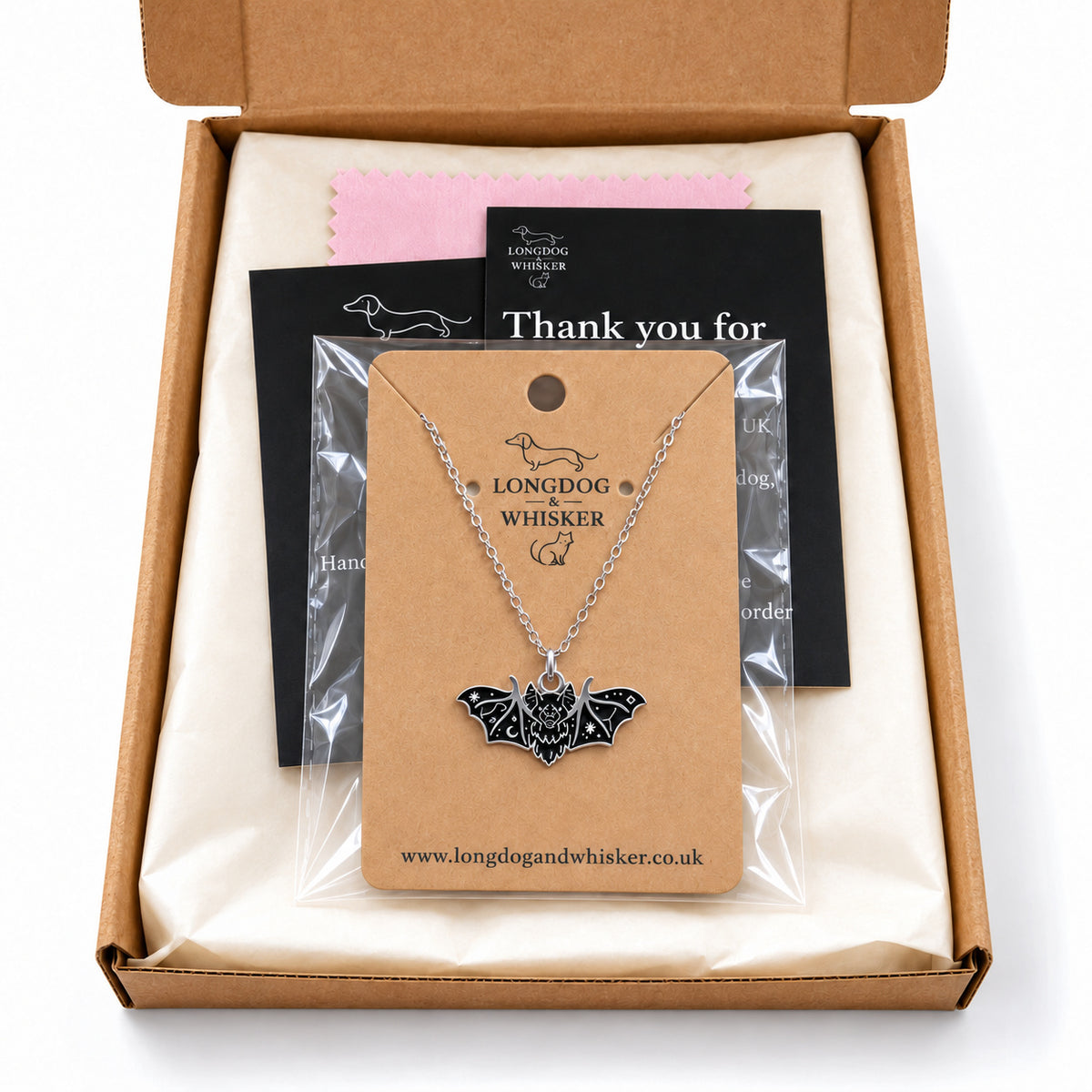 Black fanged bat necklace on its card in Longdog & Whisker gift-ready packaging