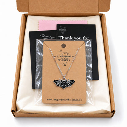 Black fanged bat necklace on its card in Longdog & Whisker gift-ready packaging