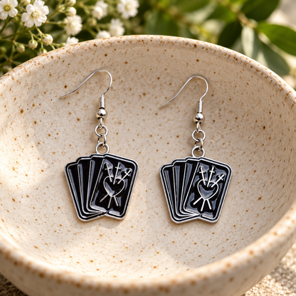 Black fortune teller card drop earrings in a speckled ceramic bowl