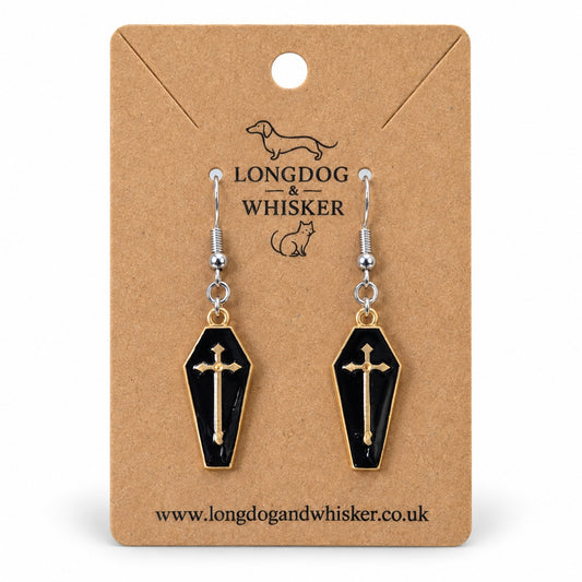 Black coffin cross earrings with gold-tone borders and silver-tone hooks on a Longdog & Whisker kraft card