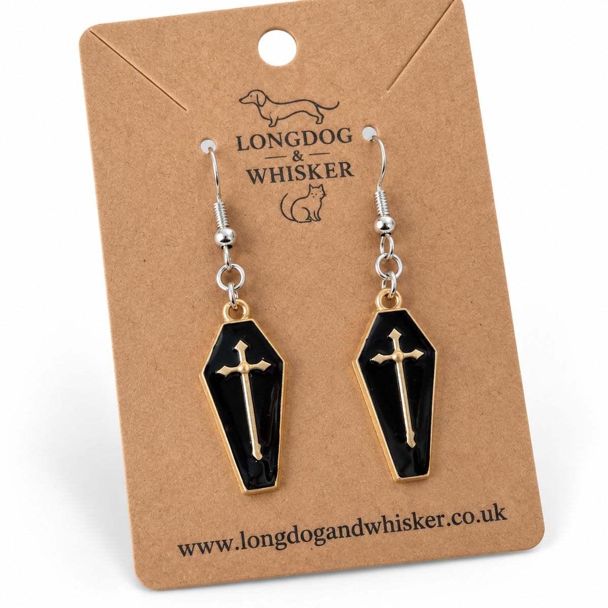 Close-up of black coffin earrings showing gold-tone crosses, borders and silver-tone connectors