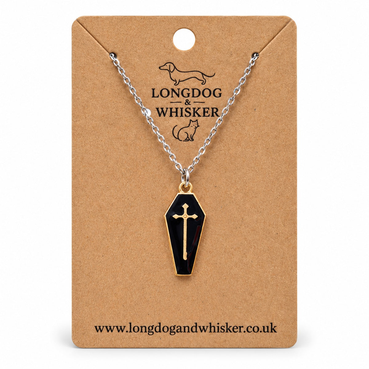 Black coffin necklace with a gold-tone cross on a silver-tone chain, displayed on a Longdog & Whisker kraft card