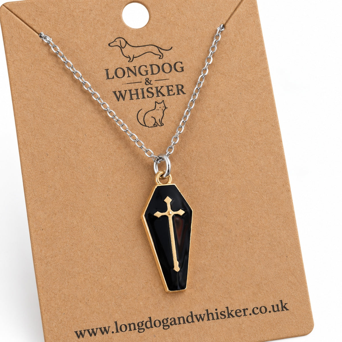 Close-up of the black coffin pendant, gold-tone cross and border, and fine silver-tone chain