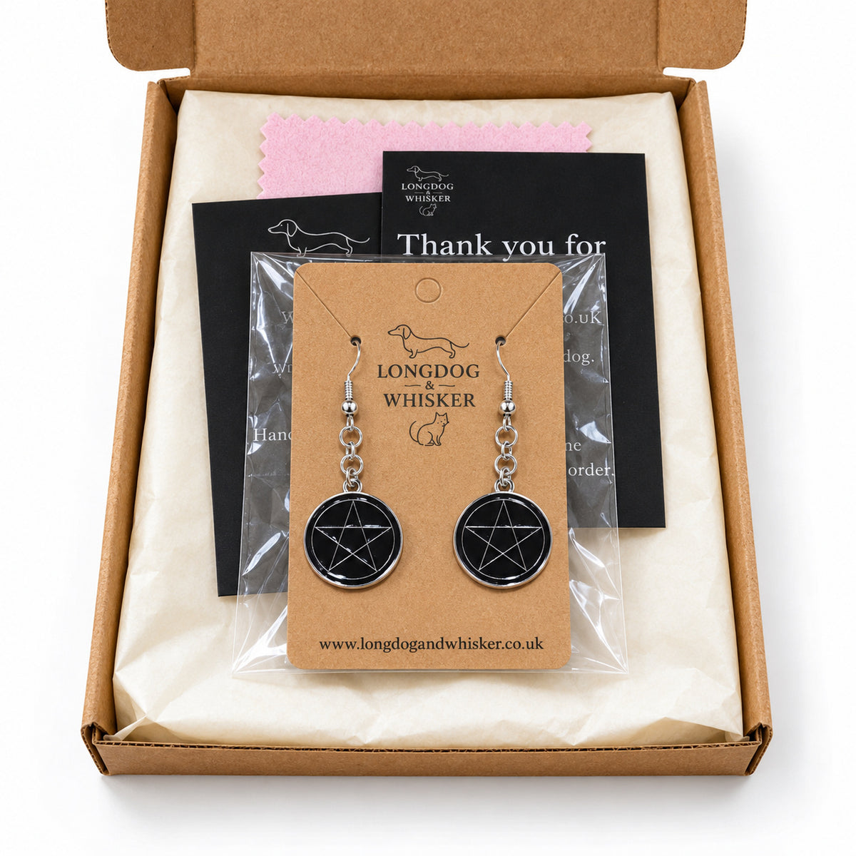 Black pentagram drop earrings presented in Longdog & Whisker postal packaging